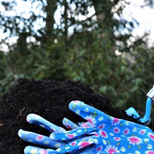 Compost with gardening tool and gloves